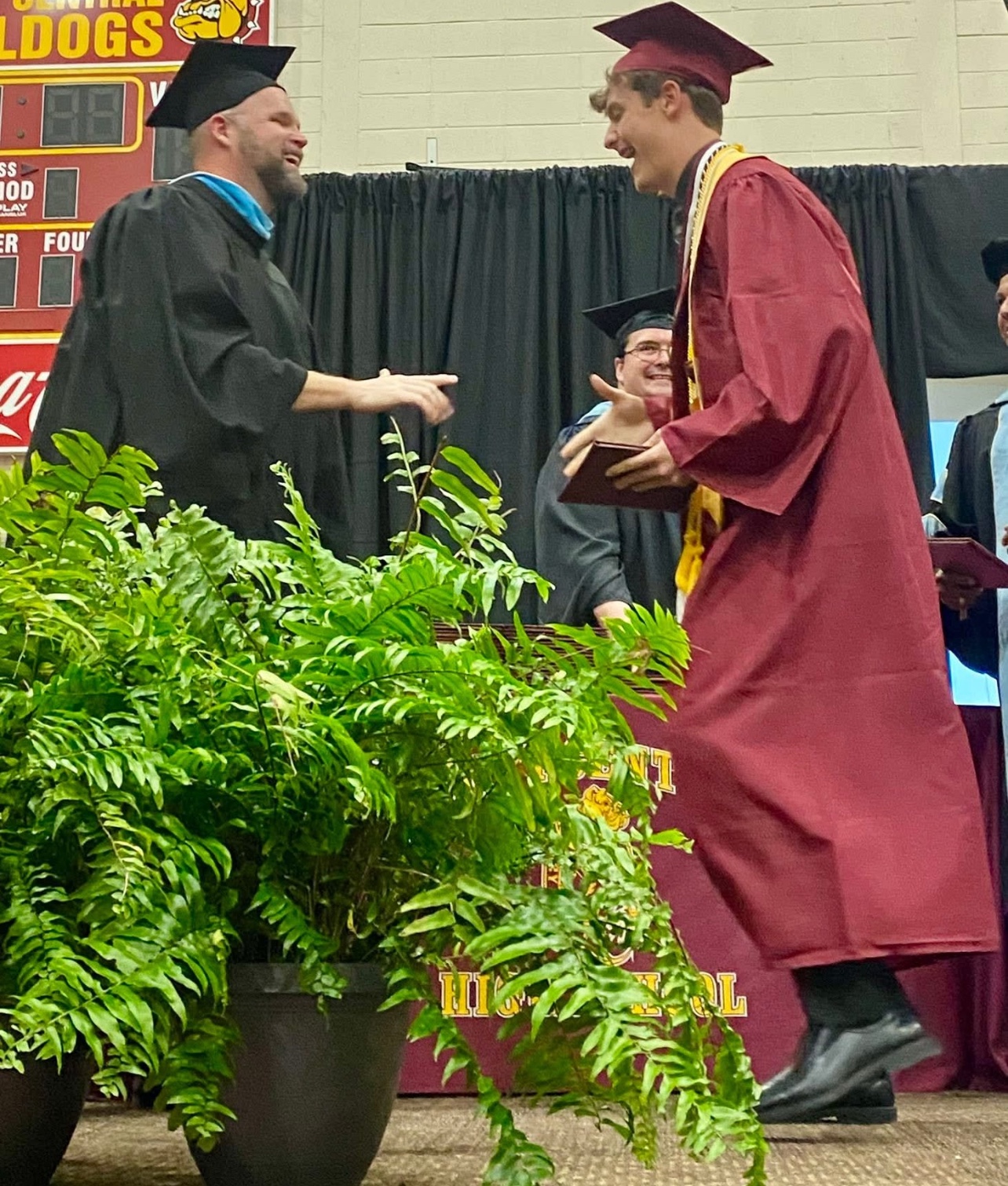 Joshua Yeager celebrating with a graduating student